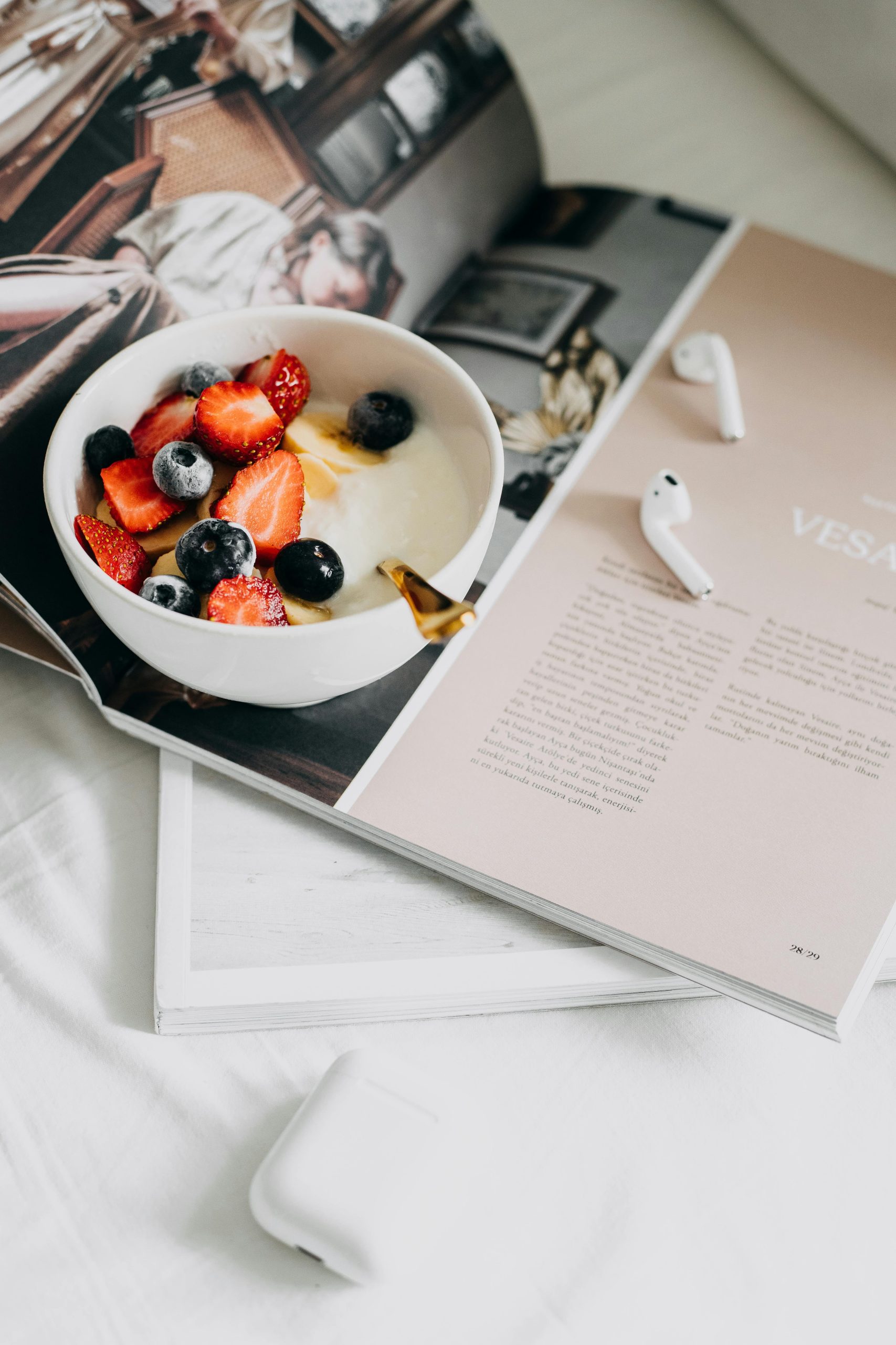 a yogurt fruit bowl resting on an open book
