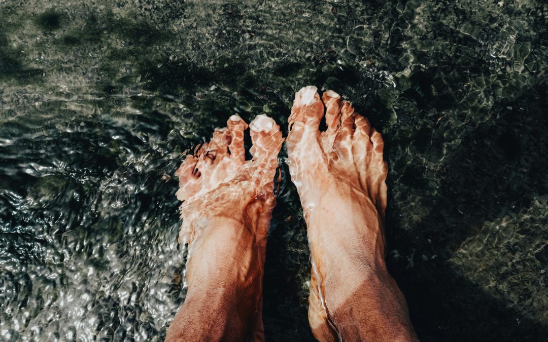 feet resting in a shallow pool of water