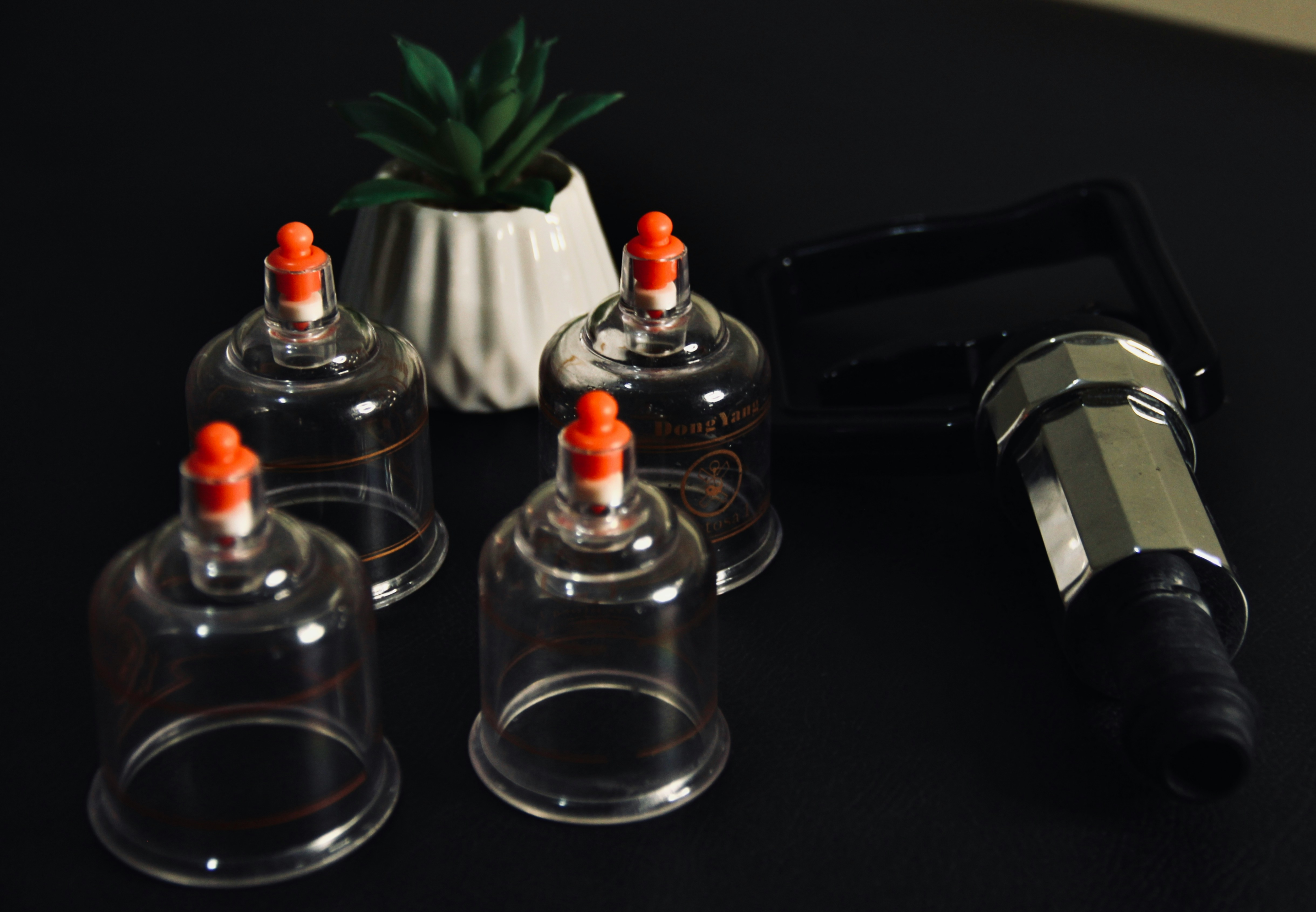 Set of cups on a black table, used for cupping therapy